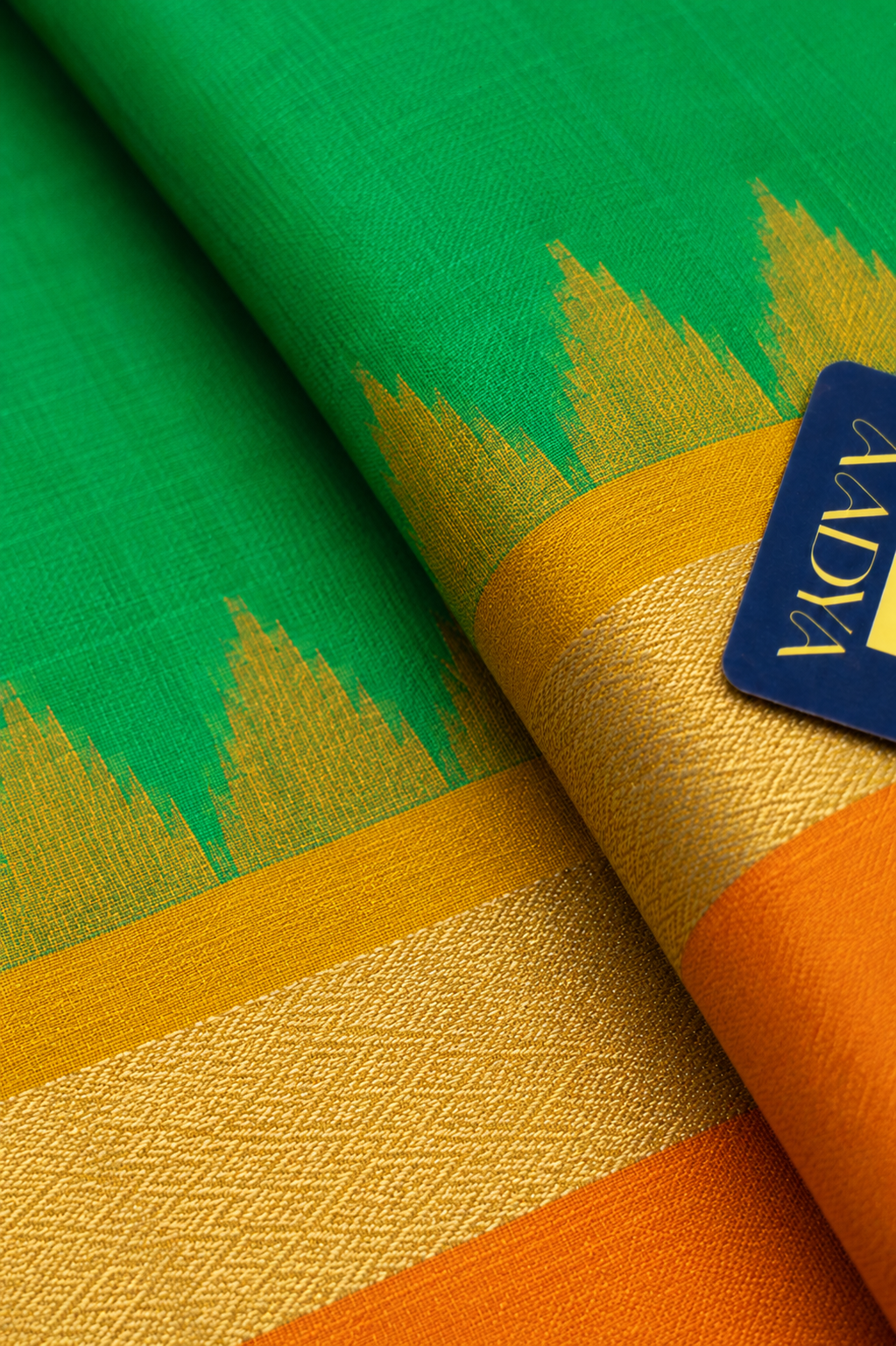 Green Puttapaka Ikkat Silk Saree with Orange & Yellow Ganga Jamuna Border