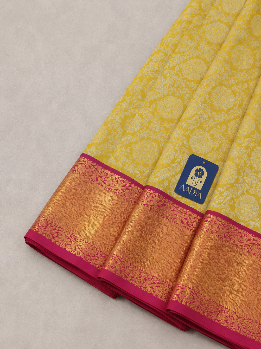Yellow Kanchivaram Silk Saree with Silver Zari Flower Buttis & Pink Border