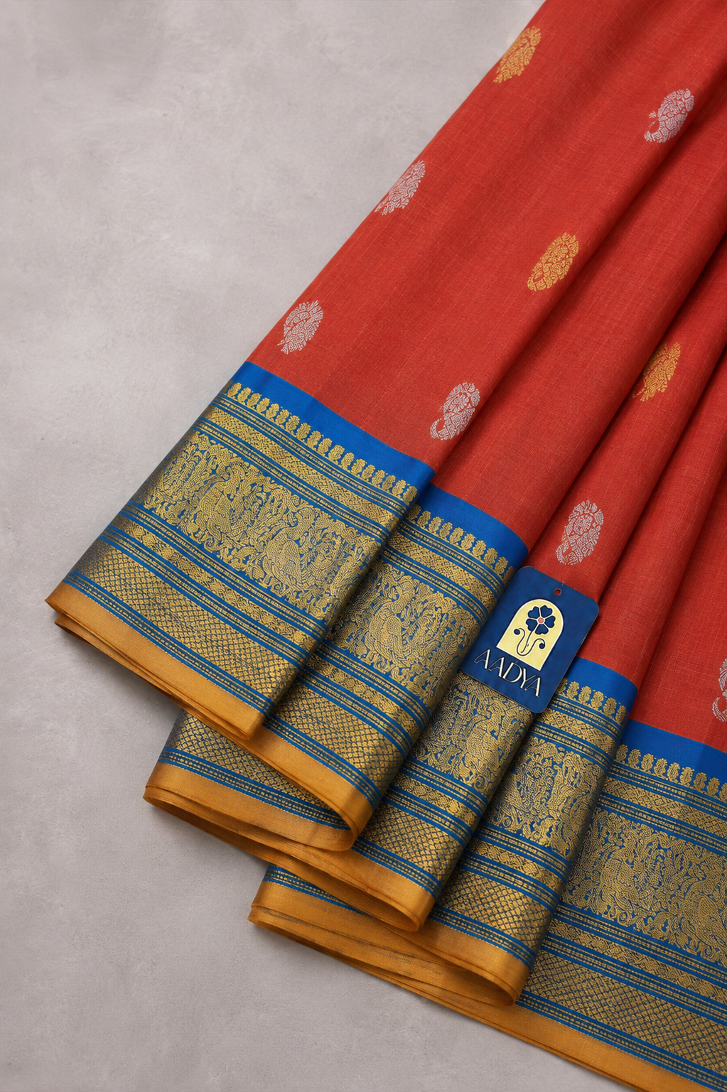 Brick Red Gadwal Silk Saree with Gold & Silver Peacock and Mango Buttis, Teal Blue Zari Border