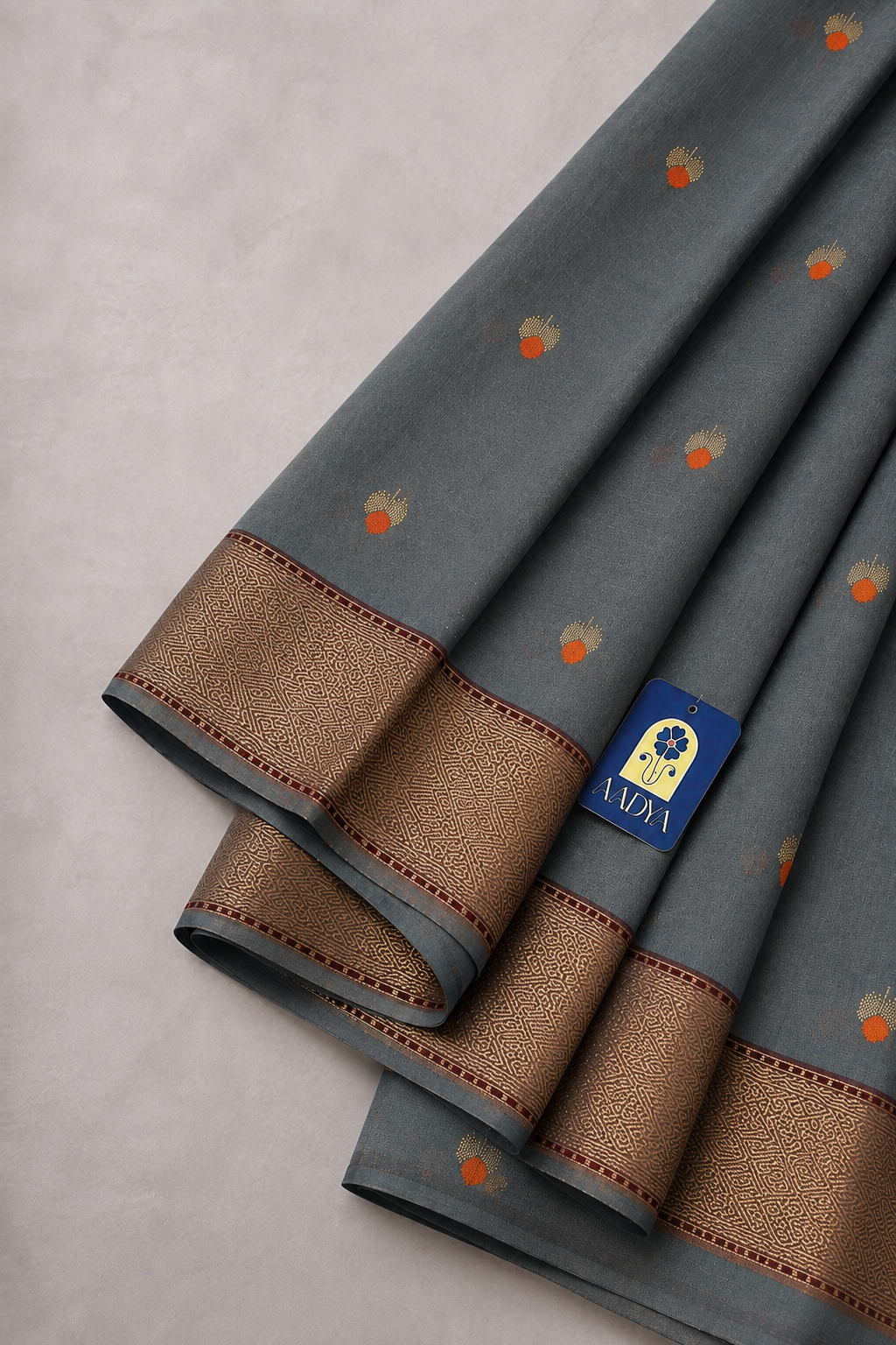 Grey Chanderi Silk Saree with Floral Meenakari Silver Buttis & Orange Cut Line Border