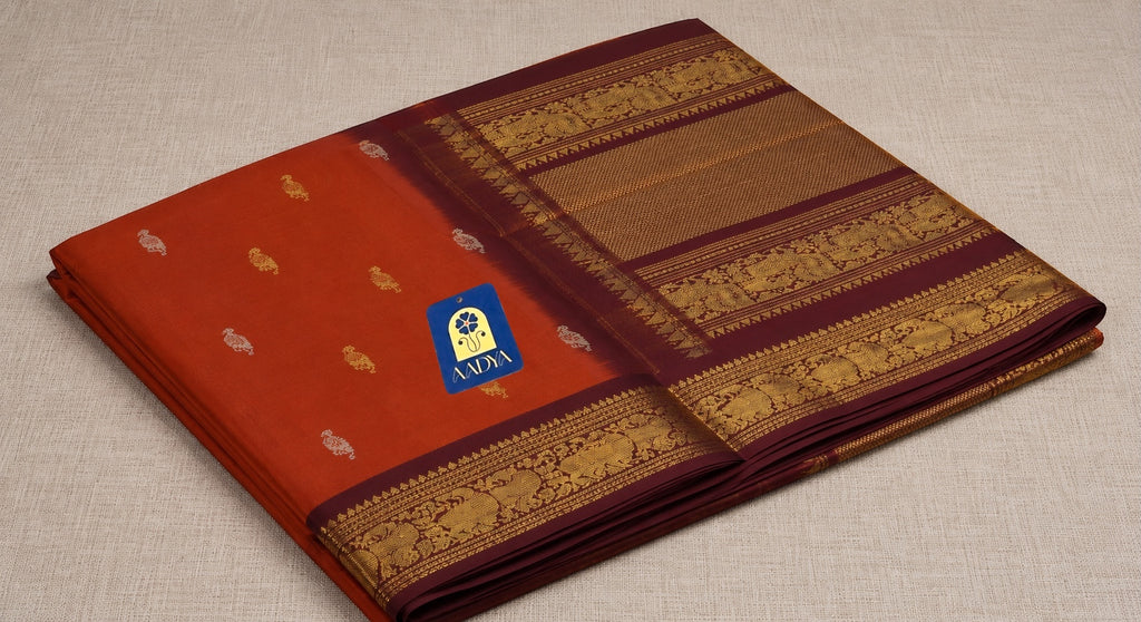 Orange Gadwal Sico Saree with Silver & Gold Deer Buttis and Maroon Zari Bird & Diamond Border