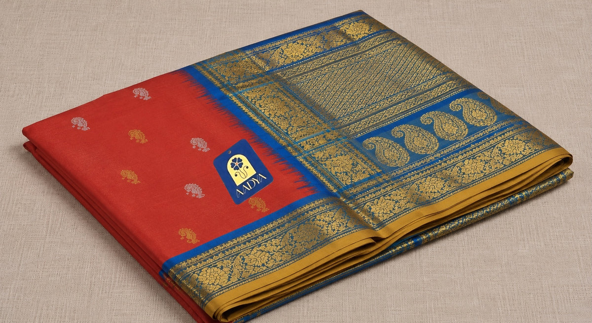 Brick Red Gadwal Silk Saree with Gold & Silver Peacock and Mango Buttis, Teal Blue Zari Border